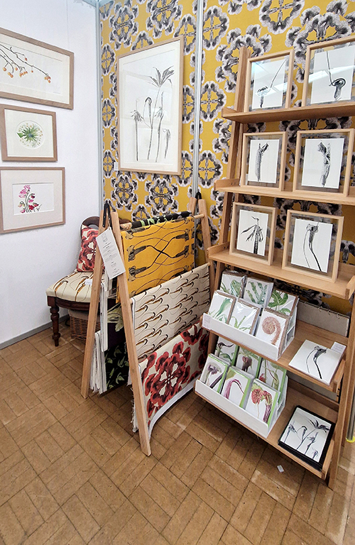 Marianne Hazlewood's Borders Art Fair display 2024, featuring botanical artwork, botanical wallpaper, botanical fabric and greetings cards