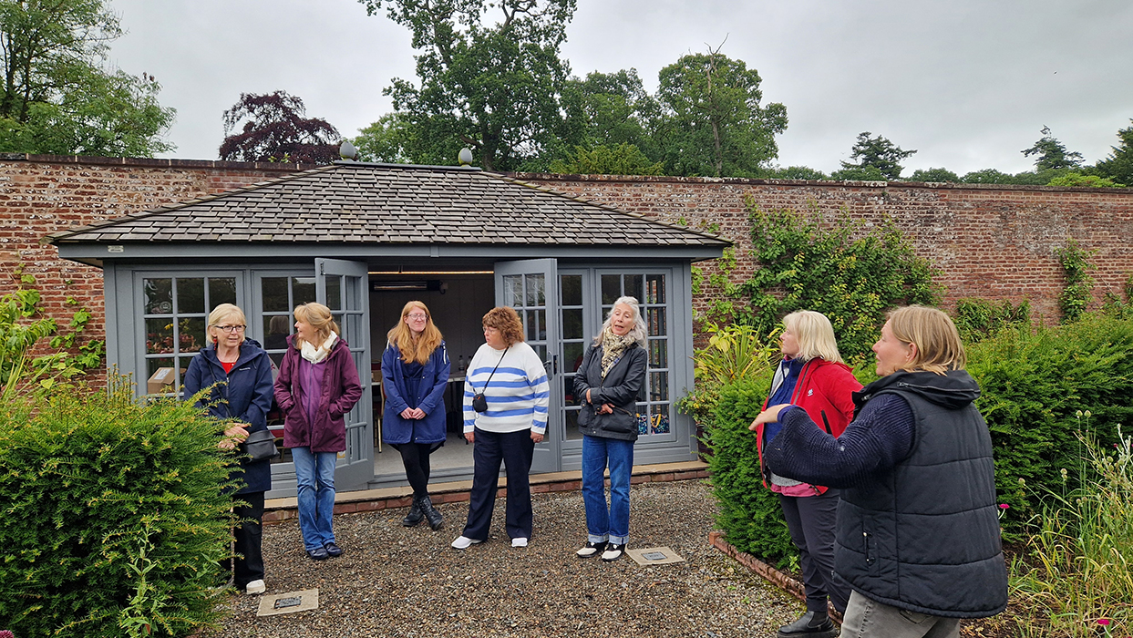 A class outside the summer house at Netherby Hall Walled Garden, ready to start drawing